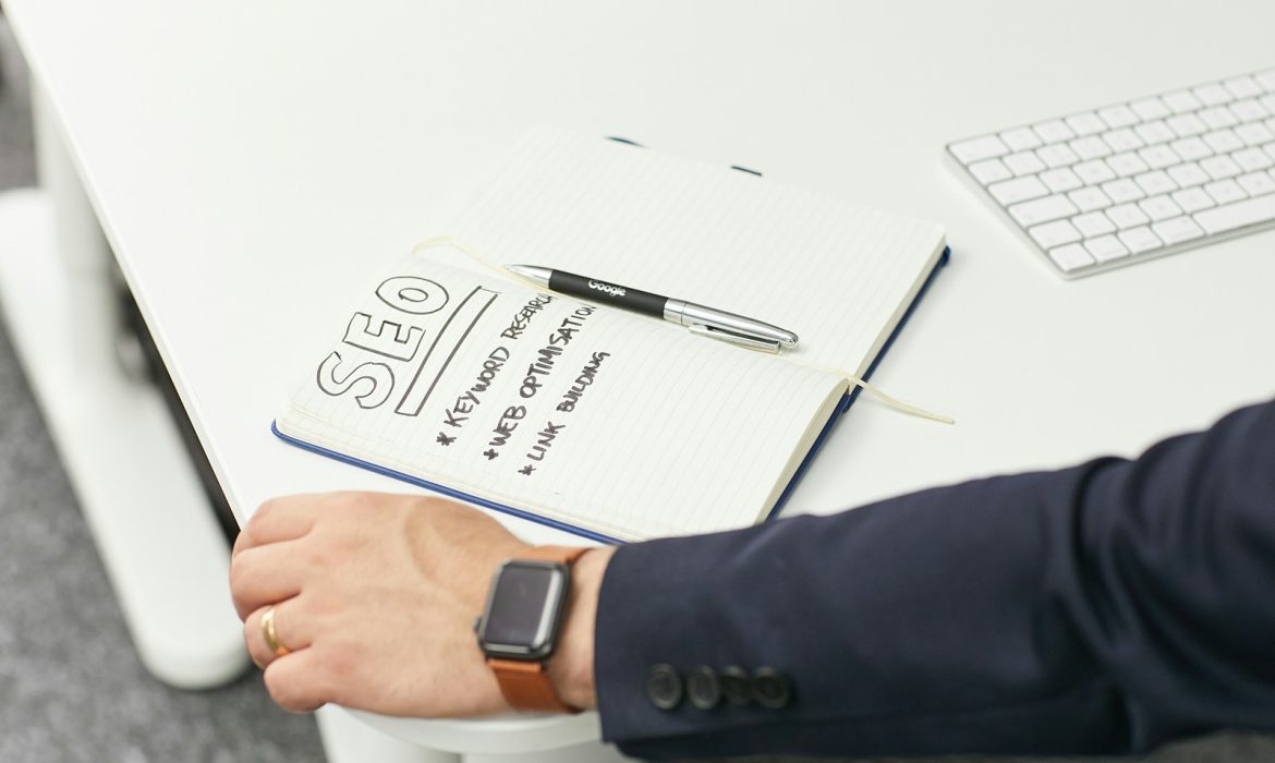 Search Engine Optimization Agency in Pakistan: a person writing on a piece of paper