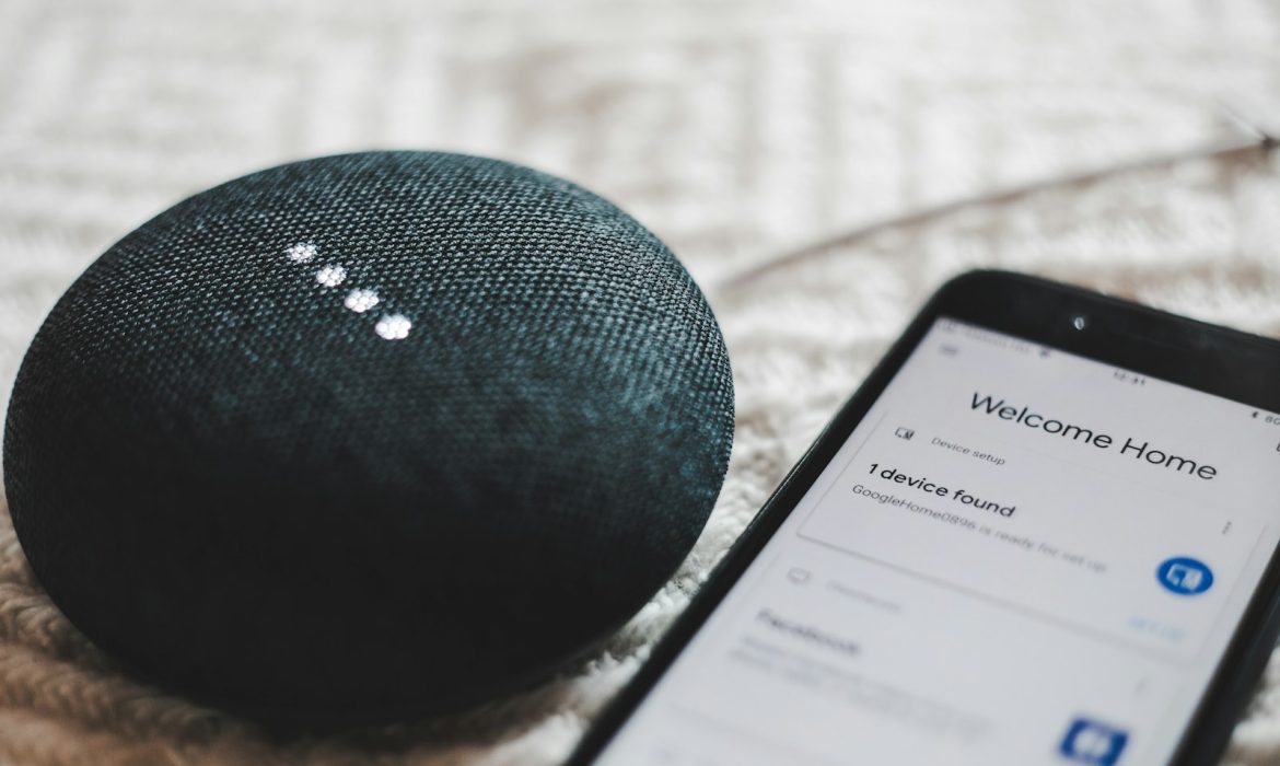 turned-on charcoal Google Home Mini and smartphone: voice search optimization
